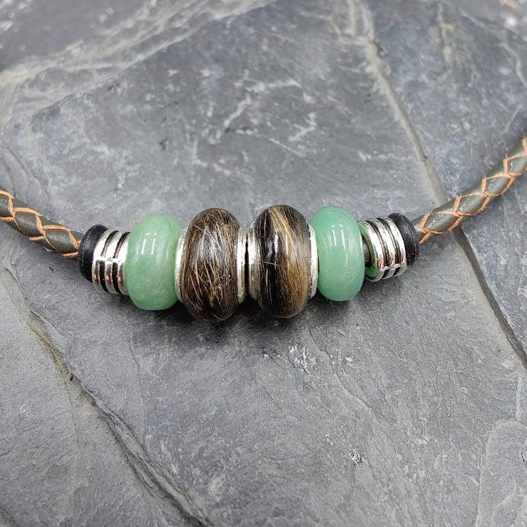 Glücksbringer Armband Lucky mit brauner Fellperle und mintgrünen Aventurin-Perlen auf geflochtenem Lederband, Nahaufnahme auf Schieferstein – Tierhaarschmuck von Zinou Minimanufaktur